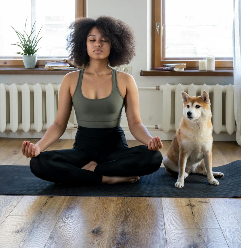 Woman Meditating Beside her Dog