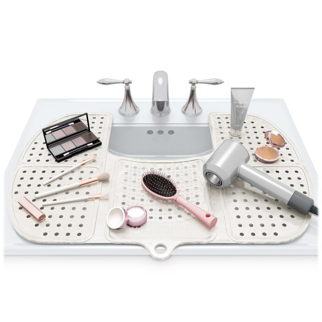 Foldable silicone mat covering bathroom sink to provide extra counter space