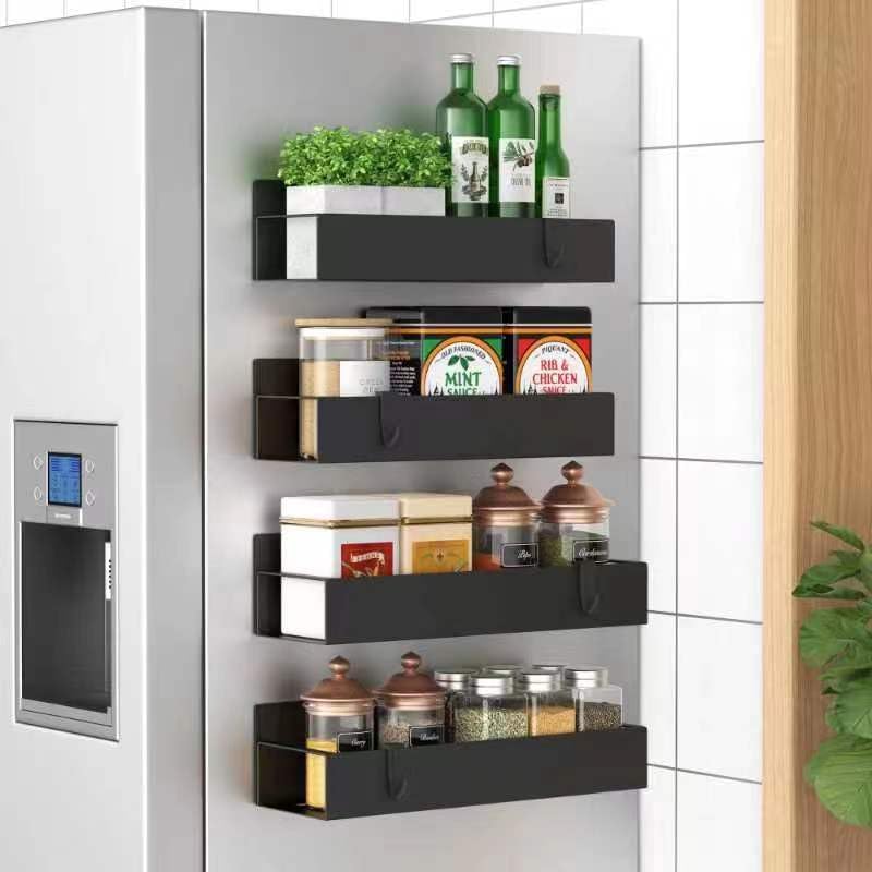 Black magnetic spice racks attached to refrigerator for compact kitchen storage